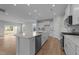 Modern kitchen with island, stainless steel appliances, and light blue backsplash at 20 Windflower Ct, Clayton, NC 27520