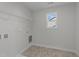 Bright laundry room with shelving and tile floor at 20 Windflower Ct, Clayton, NC 27520