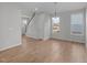 Spacious living area with wood-look floors, multiple windows, and an open layout to the kitchen and dining spaces at 20 Windflower Ct # Homesite 5, Clayton, NC 27520