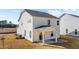 Rear exterior of a light gray two-story home with a covered porch and concrete patio at 20 Windflower Ct # Homesite 5, Clayton, NC 27520