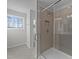 Bathroom shower with decorative tile and glass door at 20 Windflower Ct # Homesite 5, Clayton, NC 27520