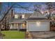 Two-story house with a white garage door, lit up at night at 211 Nichols Farm Dr, Durham, NC 27703