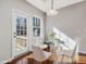Bright breakfast nook with glass table and French doors to deck at 222 Kylemore Cir, Cary, NC 27513
