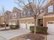 Townhome community featuring multiple brick townhomes with garages at 222 Kylemore Cir, Cary, NC 27513