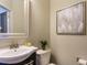 Small powder room with a white sink and toilet at 222 Kylemore Cir, Cary, NC 27513