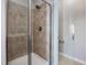 Walk-in shower with neutral tile surround at 222 Kylemore Cir, Cary, NC 27513