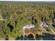 Aerial view showcasing a house's location within a lush, wooded neighborhood at 2421 New Bern Ave, Raleigh, NC 27610