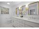 Double vanity bathroom with gold mirrors and white cabinets at 2421 New Bern Ave, Raleigh, NC 27610