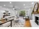 Bright living room with hardwood floors, fireplace, and French doors leading to deck at 2421 New Bern Ave, Raleigh, NC 27610