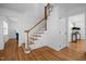 Elegant wooden staircase with white railings in a bright foyer at 2421 New Bern Ave, Raleigh, NC 27610