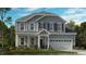 Two-story house with gray siding, white garage door, and landscaping at 2613 Stonington Dr, Cary, NC 27523