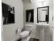 Stylish half-bathroom with modern fixtures and elegant wall decor, creating a sleek design at 3021 White Rail Dr, Fuquay Varina, NC 27526