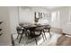 Dining area with modern chandelier, artwork, and decorative wall panel, adjacent to the living room at 3021 White Rail Dr, Fuquay Varina, NC 27526