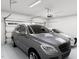 A well-lit garage featuring two parked vehicles at 3021 White Rail Dr, Fuquay Varina, NC 27526