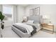 Modern bedroom with gray bedding and stylish nightstands at 3021 White Rail Dr, Fuquay Varina, NC 27526