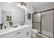 Modern bathroom featuring double sinks, sleek fixtures, and a tiled shower at 3025 White Rail Dr, Fuquay Varina, NC 27526