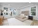 Bright bedroom featuring light-colored walls, hardwood floors, and an outdoor patio view at 3025 White Rail Dr, Fuquay Varina, NC 27526