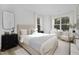 Well-lit bedroom featuring a queen bed and relaxing armchair at 3025 White Rail Dr, Fuquay Varina, NC 27526