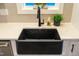 Modern farmhouse kitchen features a black farmhouse sink at 306 Quarter Gate Trce, Chapel Hill, NC 27516