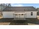 Rear view of house with white siding and covered patio at 316 Jasmine Rd, Fuquay Varina, NC 27526