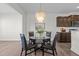 Dining area with glass table and four black chairs at 3200 Retama, New Hill, NC 27562