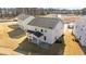 Aerial view of a two-story house with backyard and covered patio at 34 Windflower Ct, Clayton, NC 27520