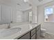 Double vanity bathroom with a window at 34 Windflower Ct, Clayton, NC 27520