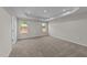 Bright bedroom with two windows, carpet, and a door at 34 Windflower Ct, Clayton, NC 27520
