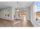 Dining room with natural light and wood flooring, complemented by windows and chandelier at 34 Windflower Ct, Clayton, NC 27520