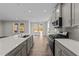 Modern kitchen with gray cabinets, stainless steel appliances, and spacious island at 34 Windflower Ct, Clayton, NC 27520