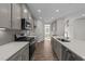Modern kitchen with gray cabinets, quartz countertops and stainless steel appliances at 34 Windflower Ct, Clayton, NC 27520