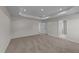 Main bedroom with carpet, two windows and access to the bathroom at 34 Windflower Ct, Clayton, NC 27520
