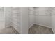 Walk-in closet with wire shelving for clothing and storage at 34 Windflower Ct, Clayton, NC 27520