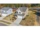 Two-story house with beige siding, white trim, and a two-car garage at 36 Railcar Way, Clayton, NC 27520