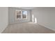 Well-lit bedroom with carpet flooring and two large windows at 36 Railcar Way, Clayton, NC 27520