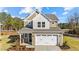 Two-story house with beige siding, white trim, and a two-car garage at 36 Railcar Way, Clayton, NC 27520