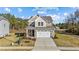 Two-story house with beige siding, white trim, and a two-car garage at 36 Railcar Way, Clayton, NC 27520