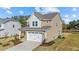 Two-story house with beige siding, white trim, and a two-car garage at 36 Railcar Way, Clayton, NC 27520