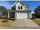 Two-story house with beige siding, white trim, and a two-car garage at 36 Railcar Way, Clayton, NC 27520