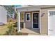 Modern front door with sidelights and a columned porch at 36 Railcar Way, Clayton, NC 27520