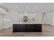 Modern kitchen with dark island and white cabinets at 36 Railcar Way, Clayton, NC 27520