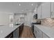 Modern kitchen with white cabinets, stainless steel appliances, and herringbone backsplash at 36 Railcar Way, Clayton, NC 27520