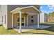 Covered patio with ceiling fan and sliding glass door at 36 Railcar Way, Clayton, NC 27520