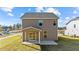 Back exterior of home with covered patio and nice backyard at 36 Railcar Way # Homesite 1, Clayton, NC 27520