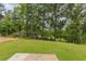 Wooded backyard with a grassy area and patio at 37 Baird Cv Ln, Angier, NC 27501