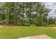 Spacious backyard with grassy area and tree lined perimeter at 37 Baird Cv Ln, Angier, NC 27501