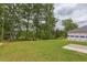 Spacious backyard with grassy area and tree lined perimeter at 37 Baird Cv Ln, Angier, NC 27501