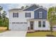 Two-story house with white and blue siding, a two-car garage, and a landscaped lawn at 37 Baird Cv Ln, Angier, NC 27501