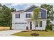 Two-story house with white and blue siding, a two-car garage, and a landscaped lawn at 37 Baird Cv Ln, Angier, NC 27501