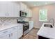Modern kitchen with white cabinets and stainless steel appliances at 37 Baird Cv Ln, Angier, NC 27501